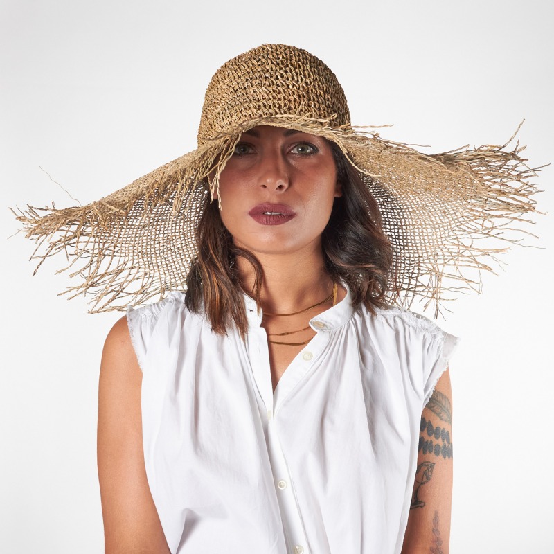 Frayed straw hat with wide brim